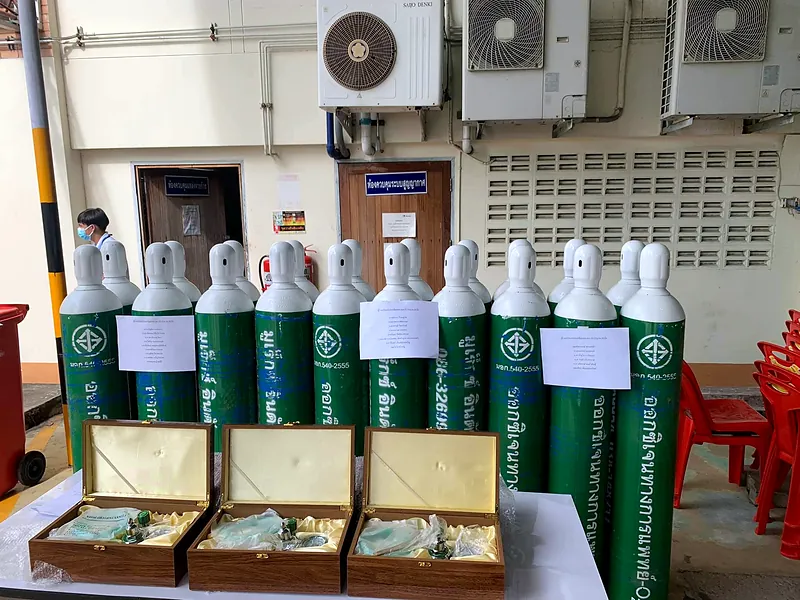 Green-and-white oxygen cylinders with oxygen regulator sets in wooden boxes